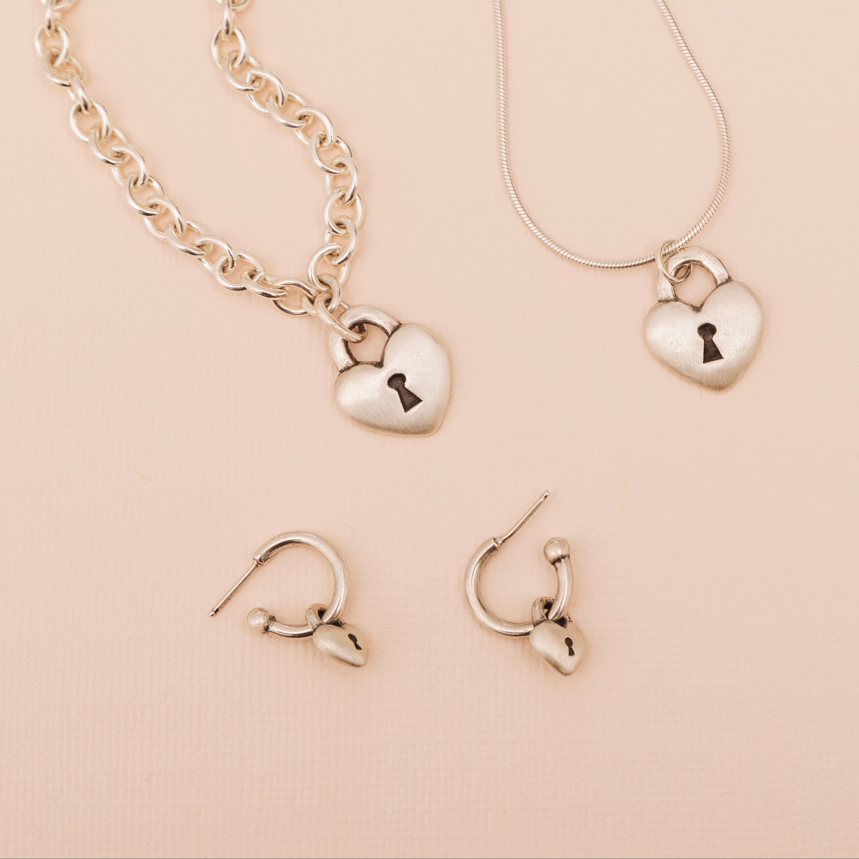 Love Lock heart hoop earrings shown with matching sterling silver Love Lock necklace and pendant