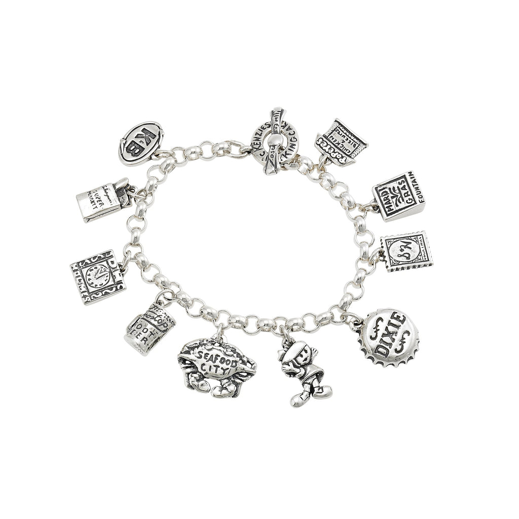 Silver charm bracelet with various charms on a white background