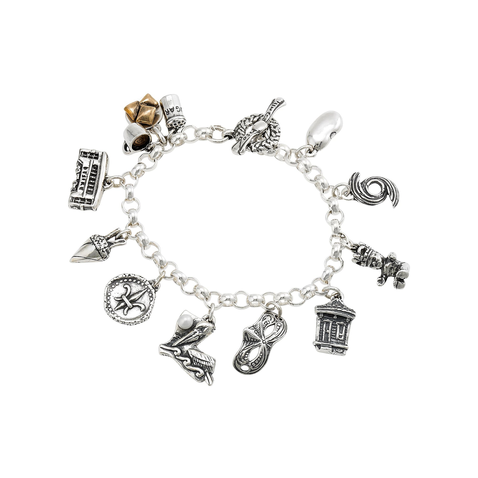 A sterling silver charm bracelet featuring a variety of hand-carved charms that represent New Orleans icons and culture, such as a king cake baby, a Mardi Gras mask, and beignets with coffee.