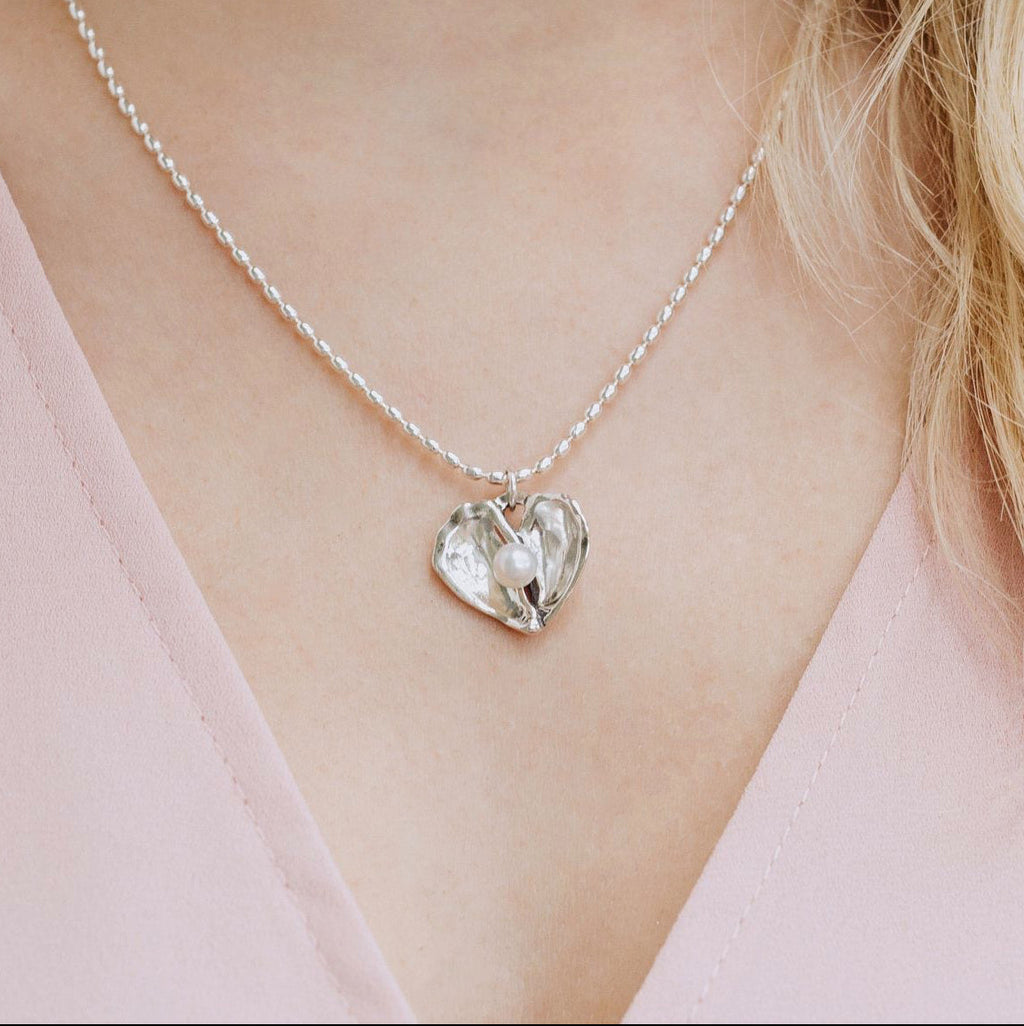 woman wearing oyster heart necklace — pearl heart pendant necklace