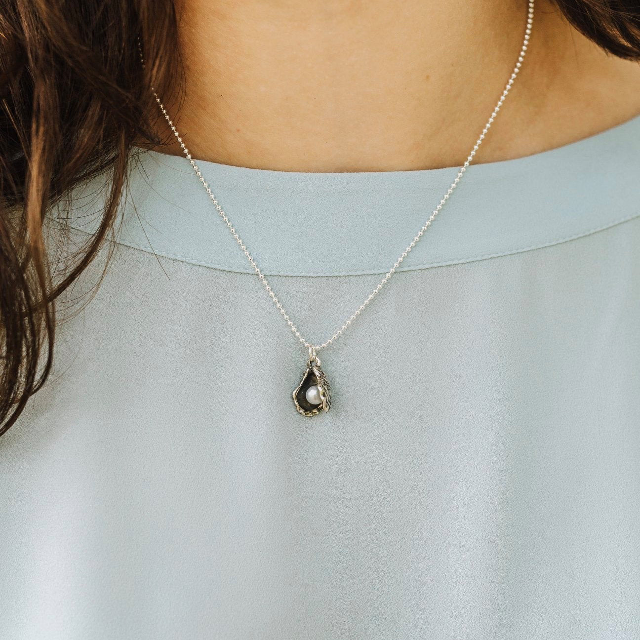 oyster pearl pendant worn on necklace sterling silver jewelry new orleans design