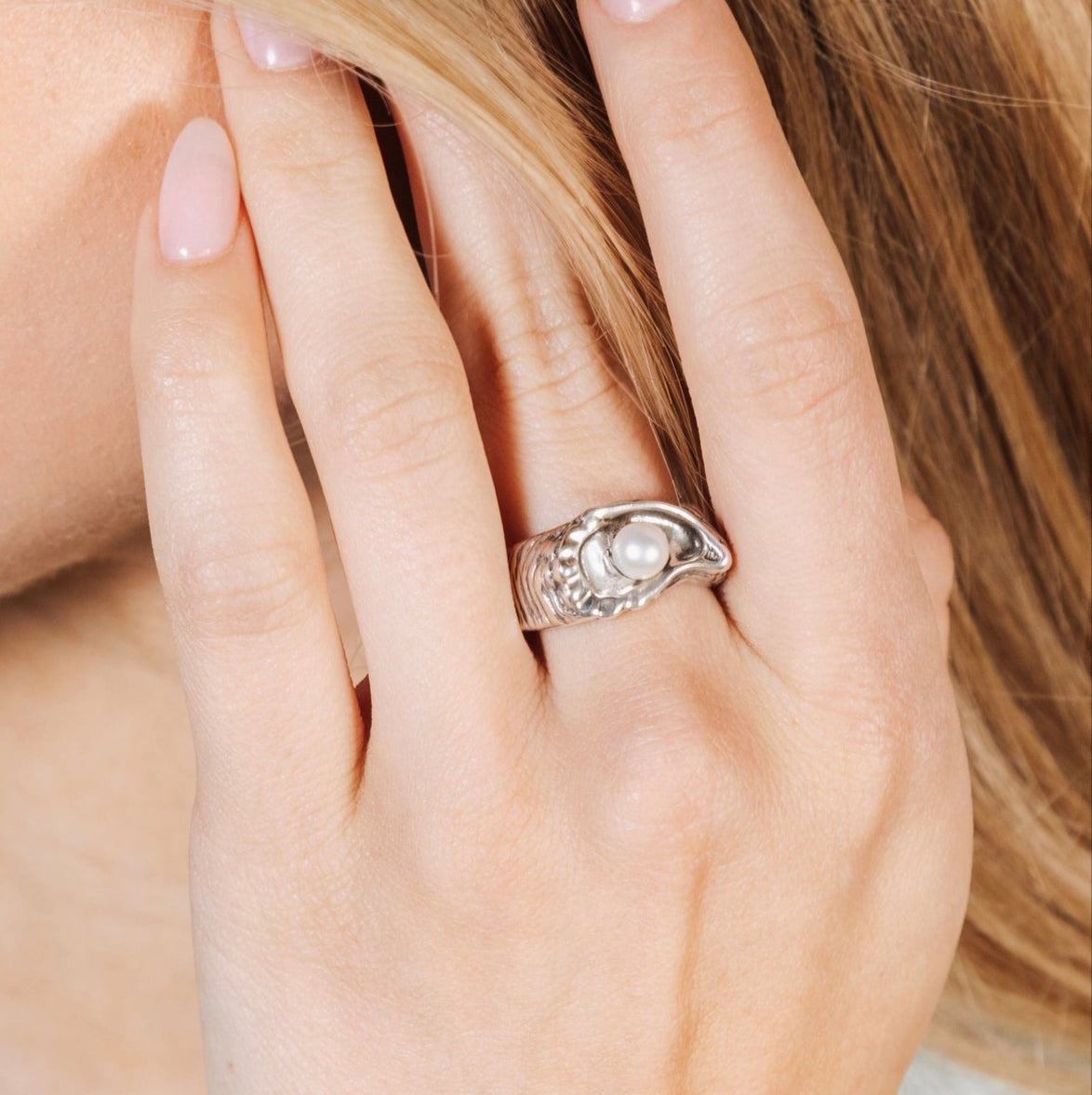large oyster pearl statement ring worn on hand showing bold size and sculptural detail