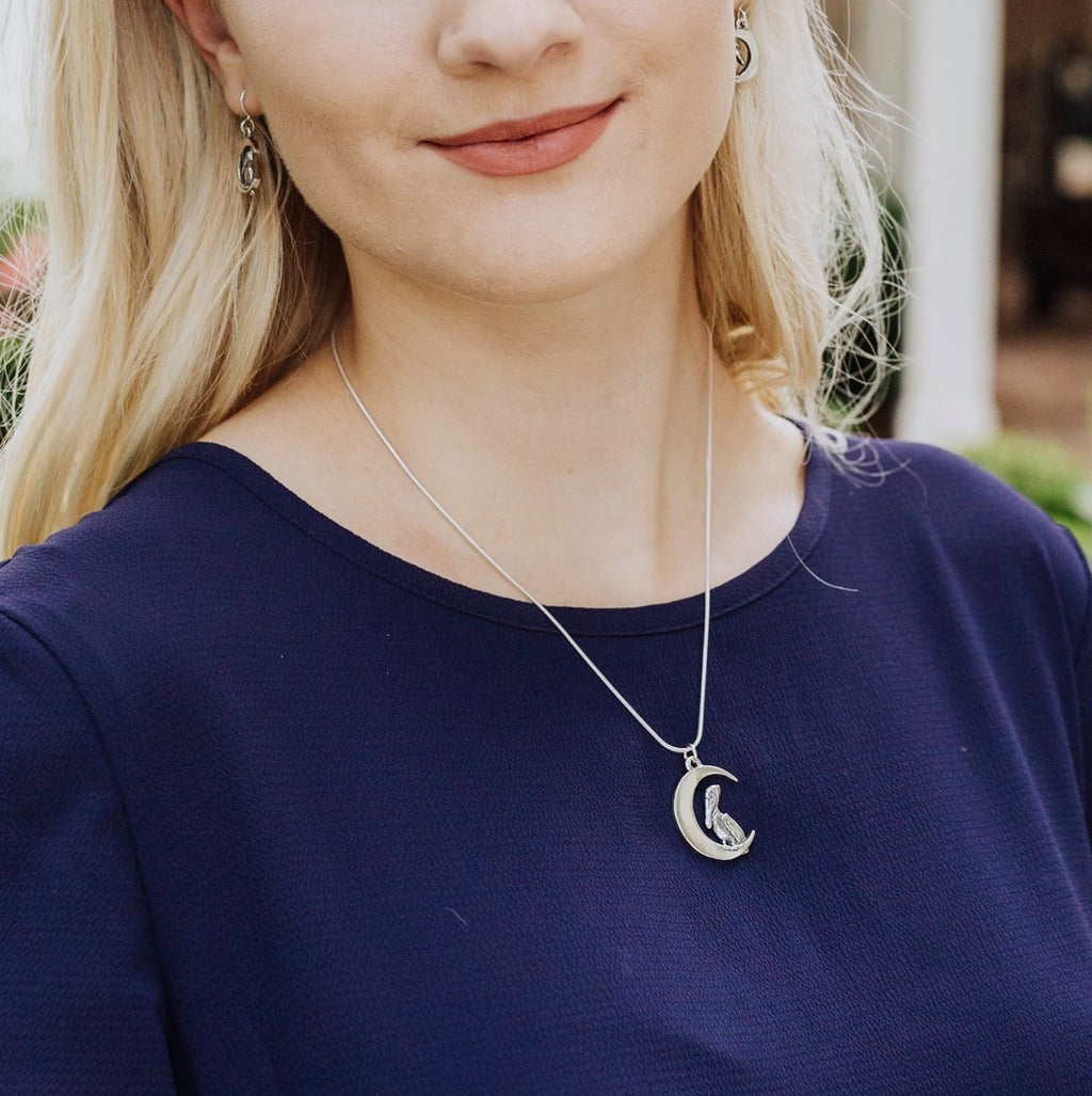sterling silver pelican moon pendant worn by model, unique crescent moon jewelry from new orleans