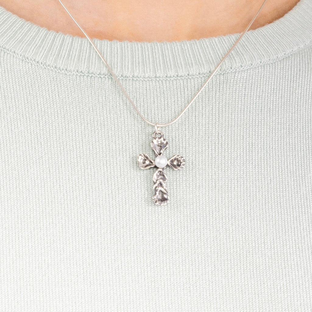 Sterling silver oyster pearl cross necklace worn on model