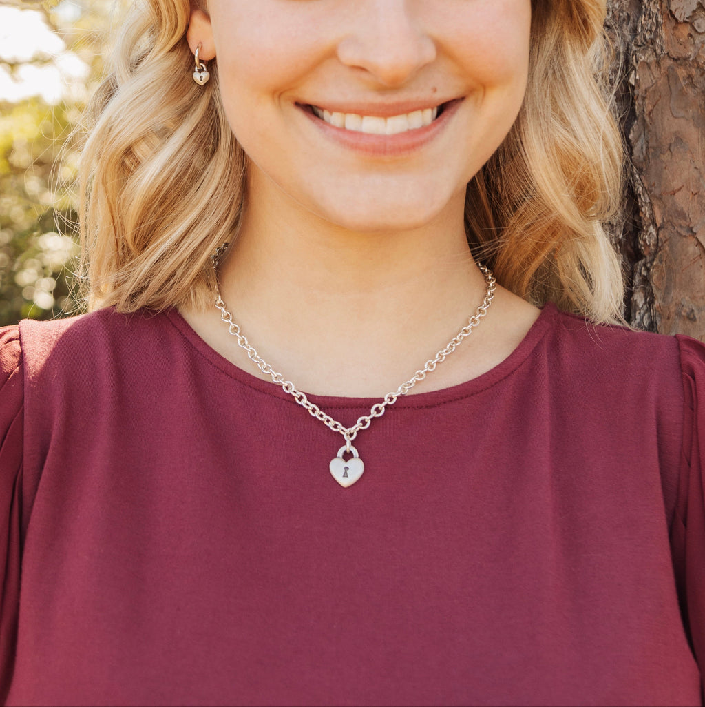 Woman wearing sterling silver heart love lock necklace with engraved treasure message