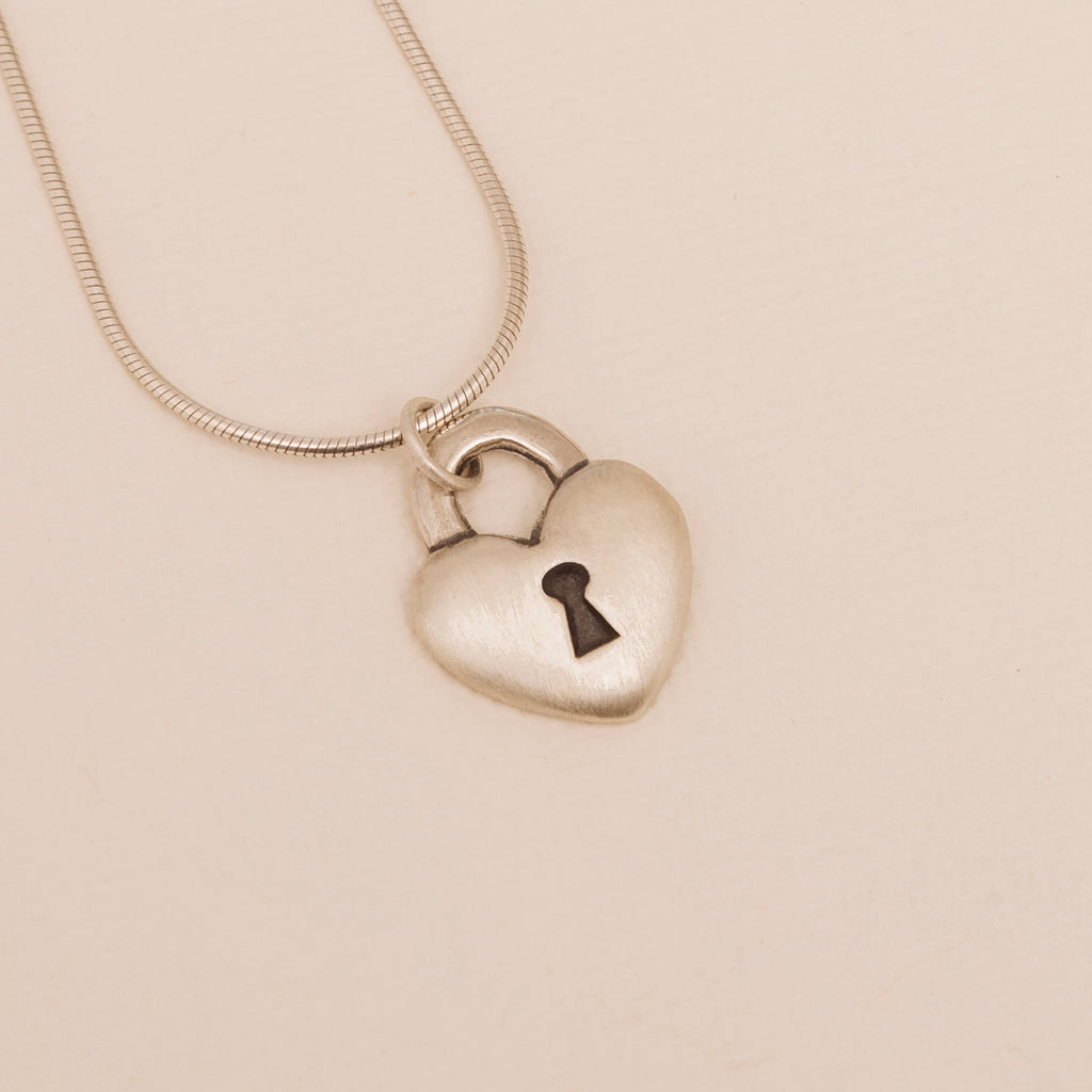 Sterling silver love lock heart pendant with keyhole detail front close up 